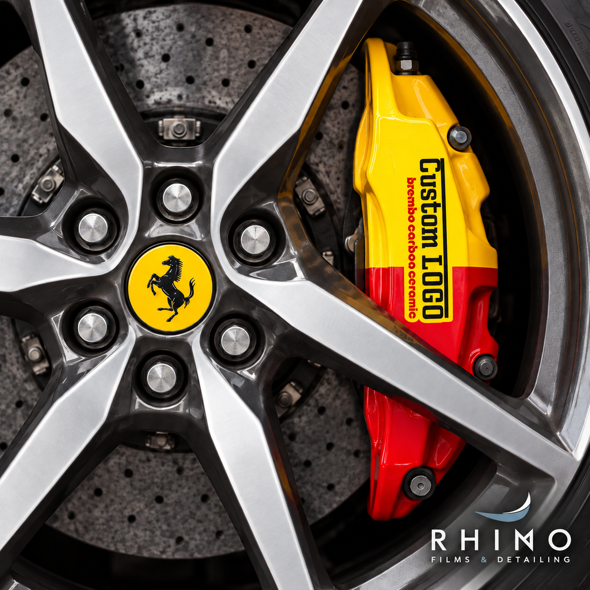 Sample yellow and red brake caliper with Custom LOGO lettering behind alloy wheel spokes.